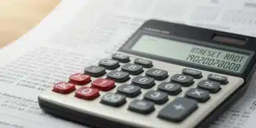 Calculator displaying higher interest rates on student loan documents, symbolizing the financial burden of rising rates by 2026.